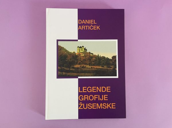 Izdelek "Legende grofije Žusemske" ima vijolično-belo naslovnico z ilustracijo gradu na hribu, obkroženega z drevesi, na rožnati podlagi.